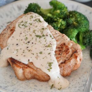 A Ranch pork chop with broccoli