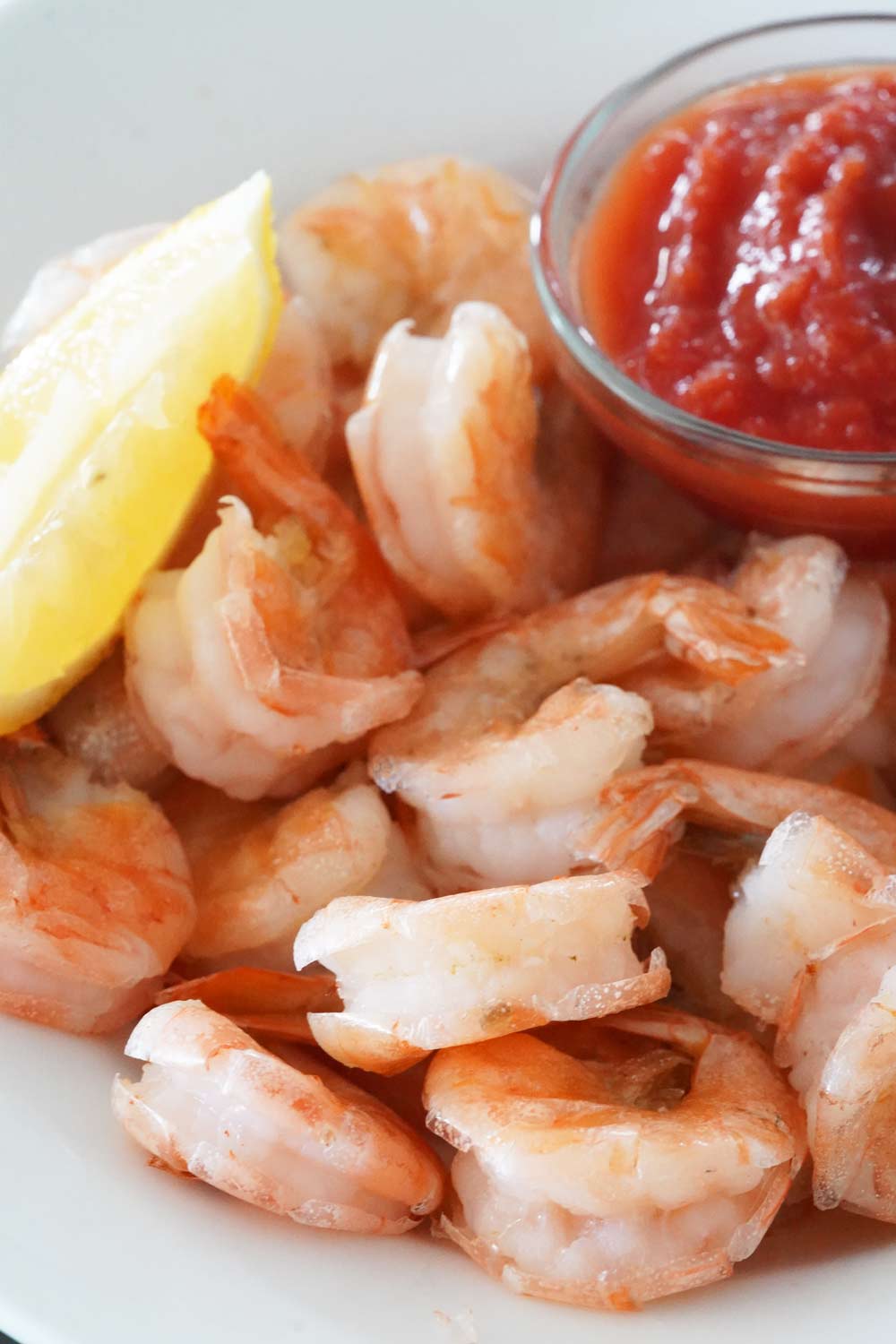 cooked shrimp with lemon and cocktail sauce