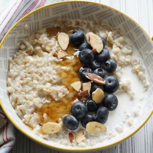 Instant Pot Steel Cut Oats with blueberries, honey, and almonds.